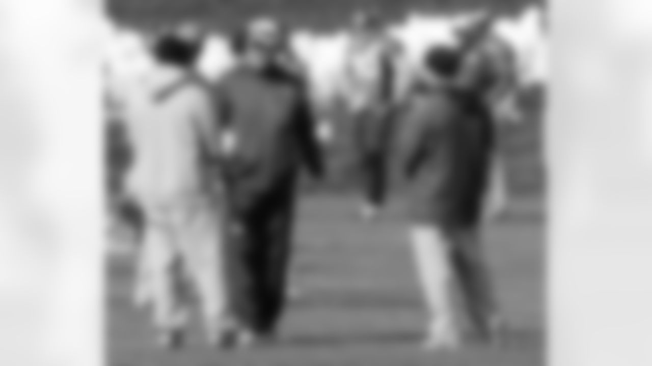 Head Coach John Fox chats with his coaches during Friday's practice.