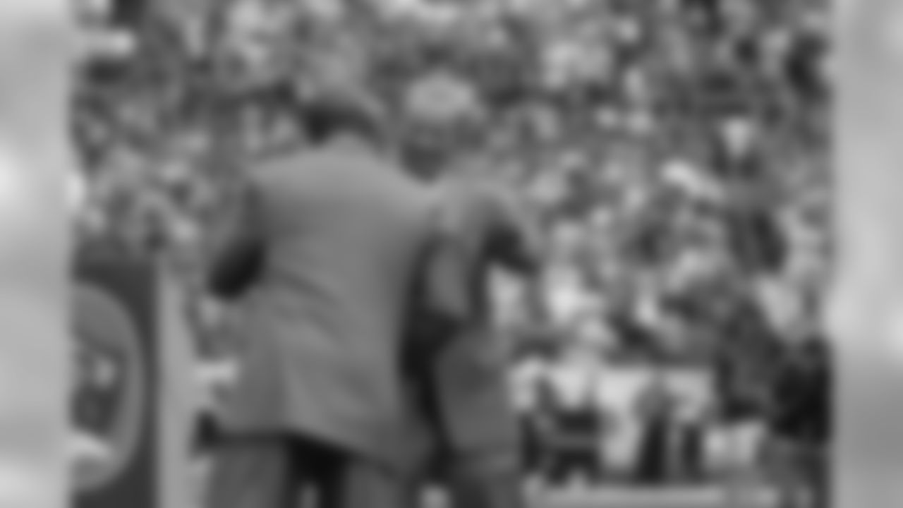 Terrell Davis gives thanks and a hug to Pat Bowlen at the conclusion of the ceremonies for Davis's induction into the Ring of Fame at Invesco Field at Mile High.