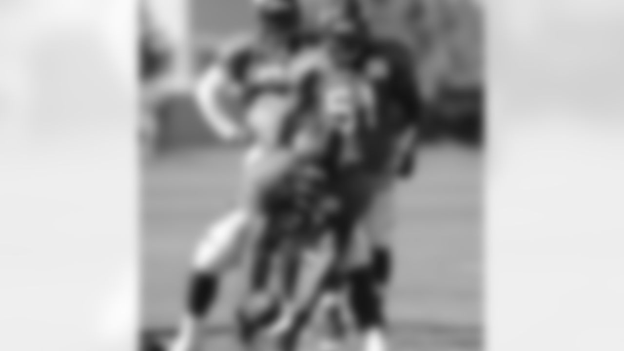 LB Nate Irving scoops up a loose ball as the rest of the linebacker look on.