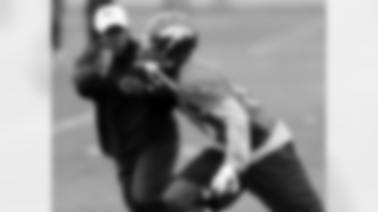 WR Gerell Robinson works against WR Coach Tyke Tolbert during a drill.
