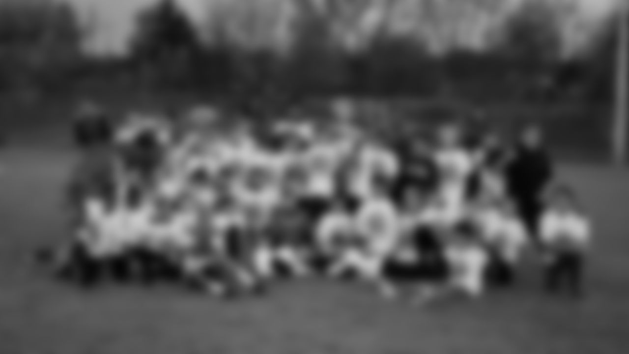 Brendan Langley takes a group photo with the participants at his youth football camp on June 15, 2019.