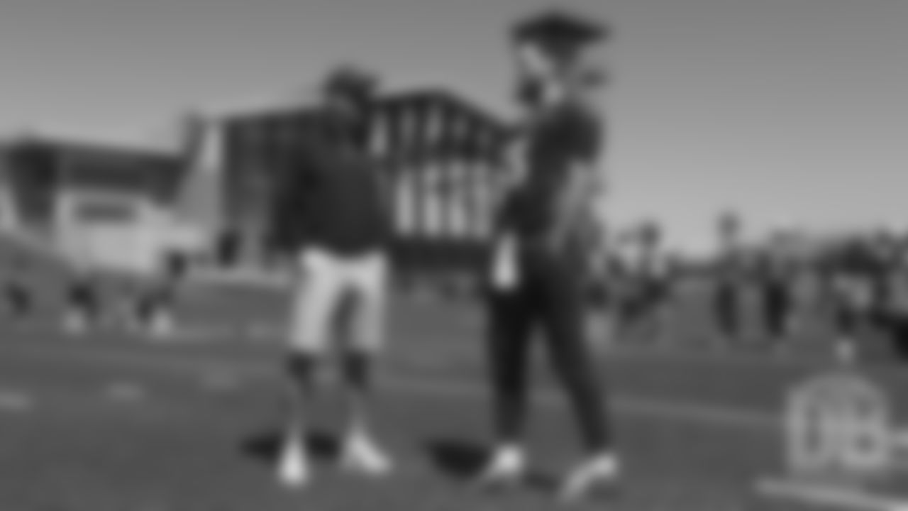 Joe Flacco talks with former Broncos quarterback Peyton Manning during the Broncos' practice on the eight day of their OTAs on May 30, 2019.