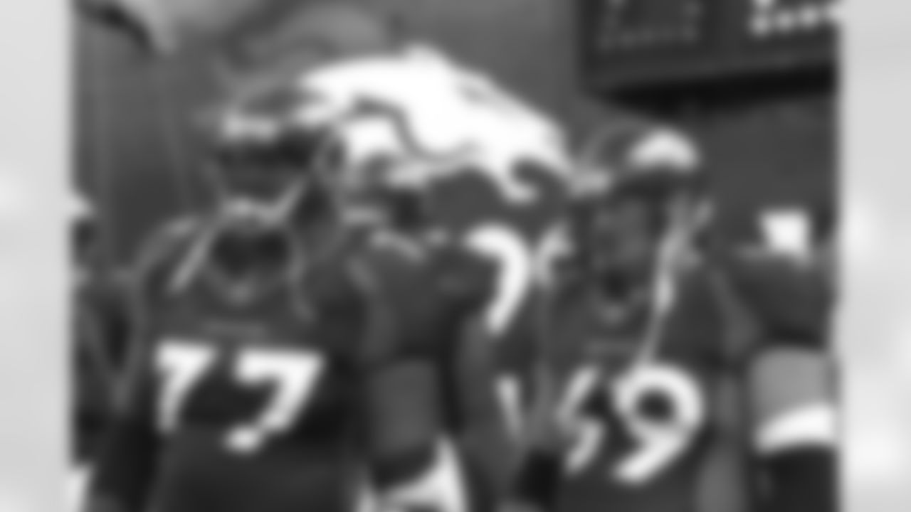 Tony Jones and Mark Schlereth wait for the pre-game announcements against the New England Patriots at Mile High Stadium in Denver, CO on September 7, 1998.
