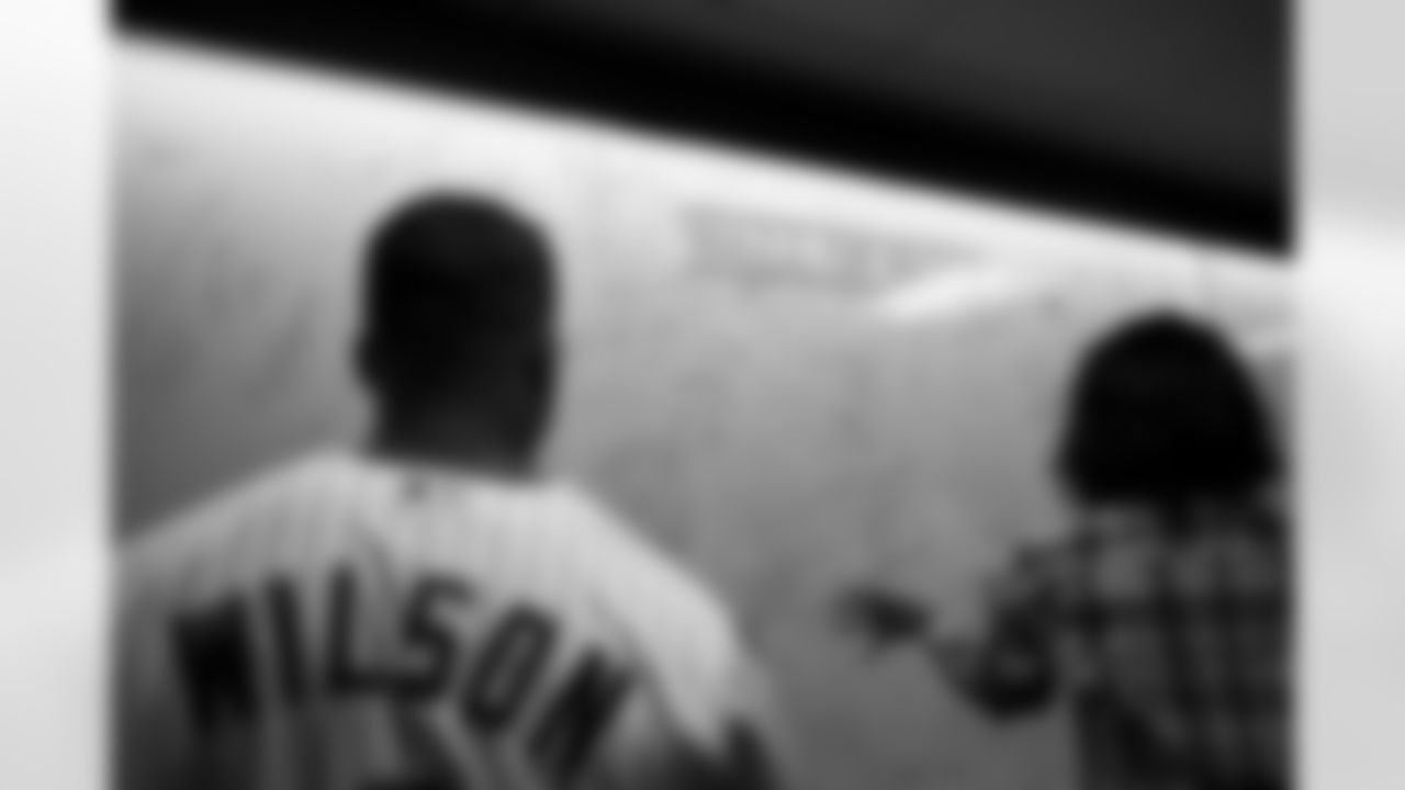 Russell Wilson and Ciara sign the Rockies' Wall of Fame during his visit to the Colorado Rockies' Opening Day game at Coors Field in Denver, Colorado on April 8, 2022. (Photo by Ben Swanson)