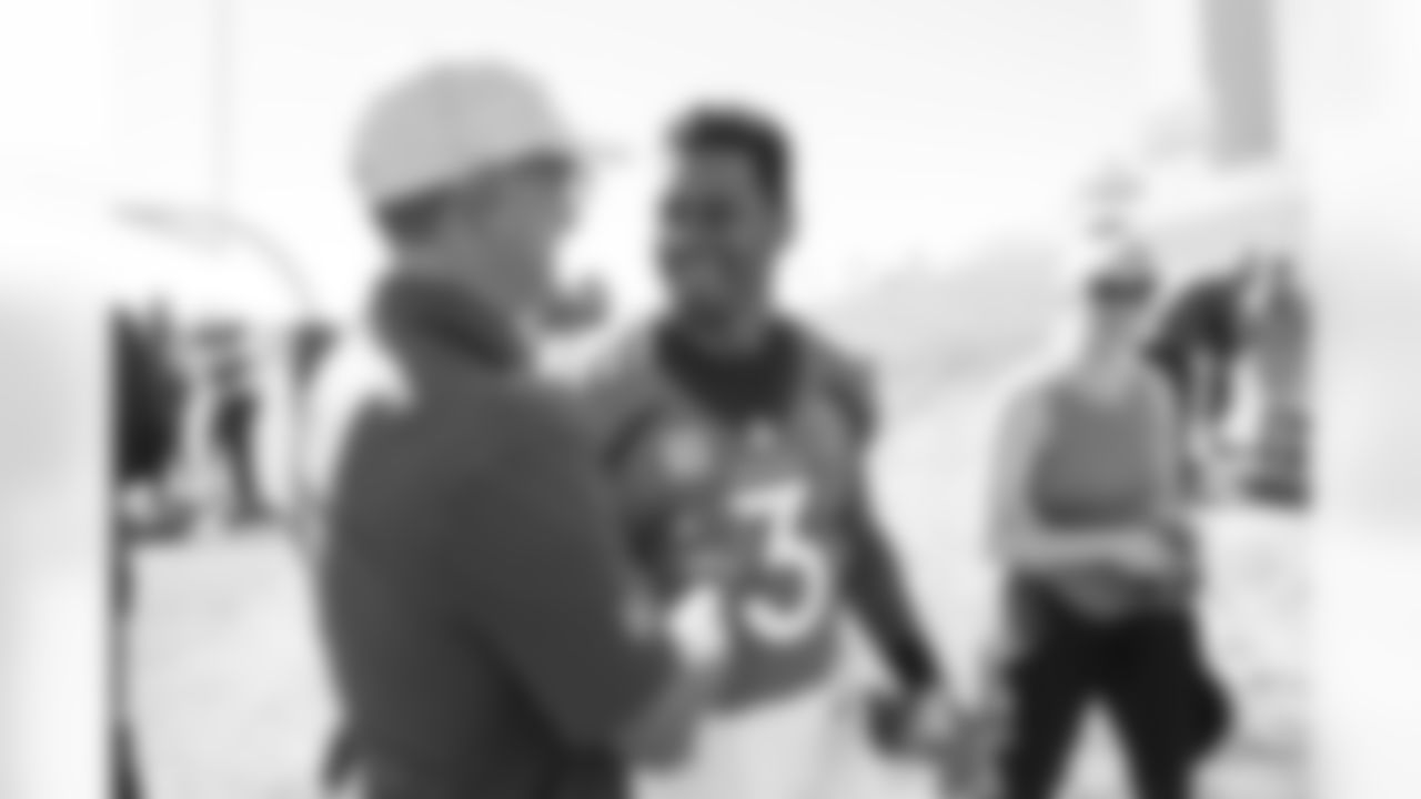 Russell Wilson greets Greg Penner at the Broncos' family breakfast during walkthrough at UCHealth Training Center in Englewood, Colorado on September 24, 2022. (Photo by Ben Swanson)