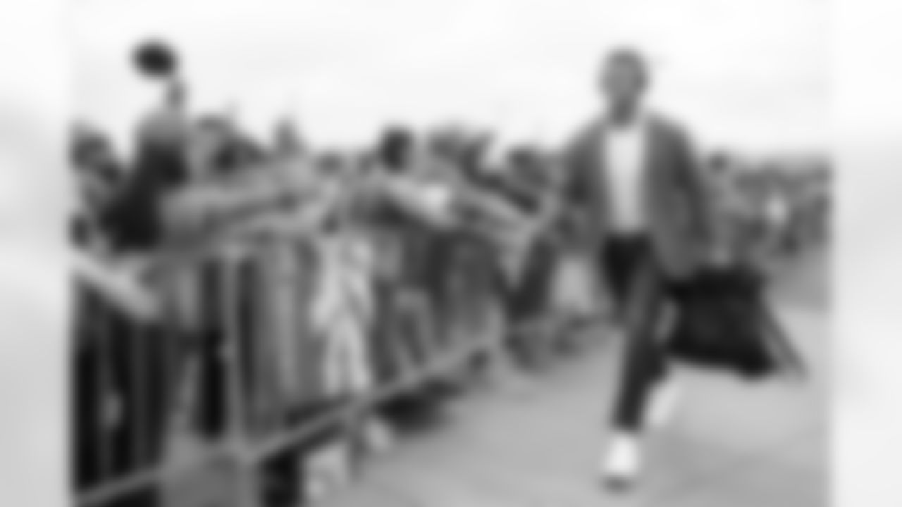 Mike McGlinchey high-fives fans during team arrivals before the Broncos' Week 1 game against the Las Vegas Raiders at Empower Field at Mile High in Denver, Colorado on September 10, 2023. Photo by Ben Swanson / Denver Broncos