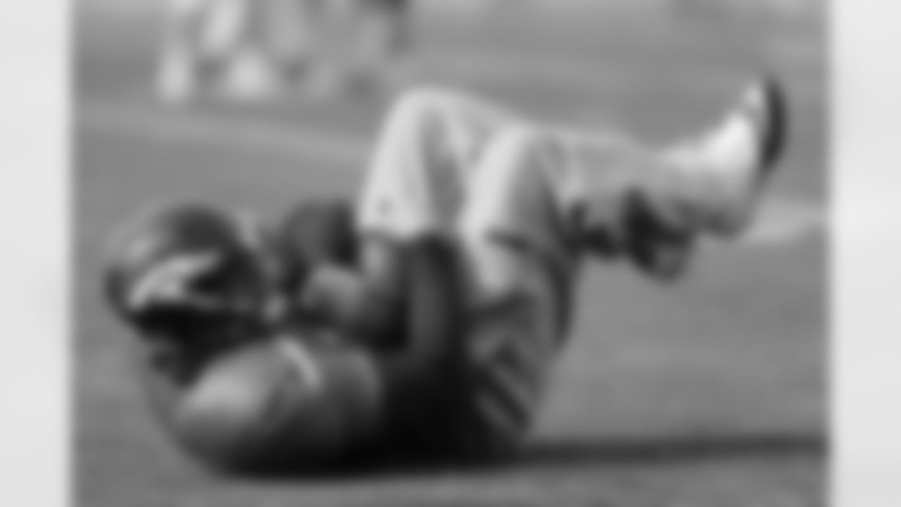 QB Caleb Hanie practices covering up a loose ball.