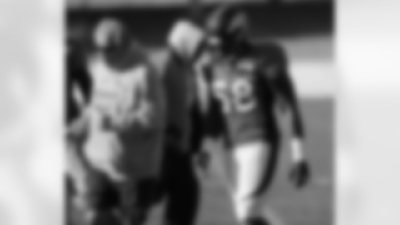 LB Coach Richard Smith and LB Von Miller talk on their way to start a drill.