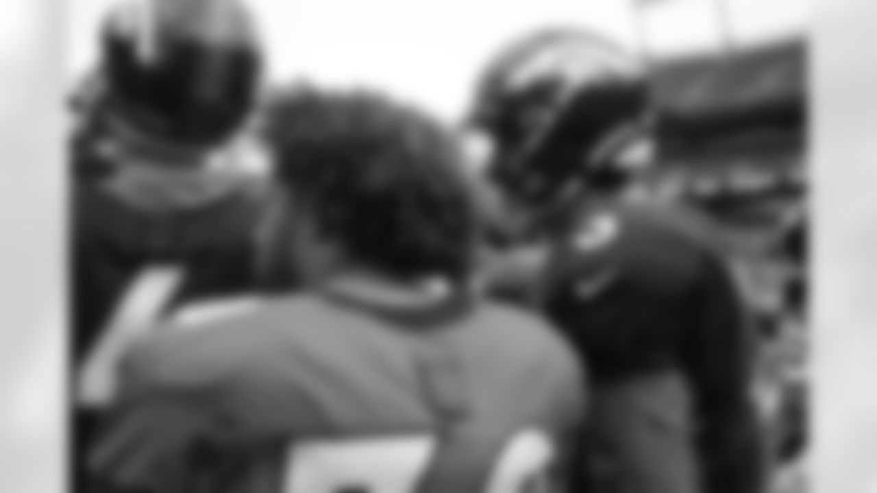 Drew Lock talks with Phillip Lindsay during practice on Day 12 of training camp at Empower Field at Mile High on August 29, 2020. (Photo by Ben Swanson)