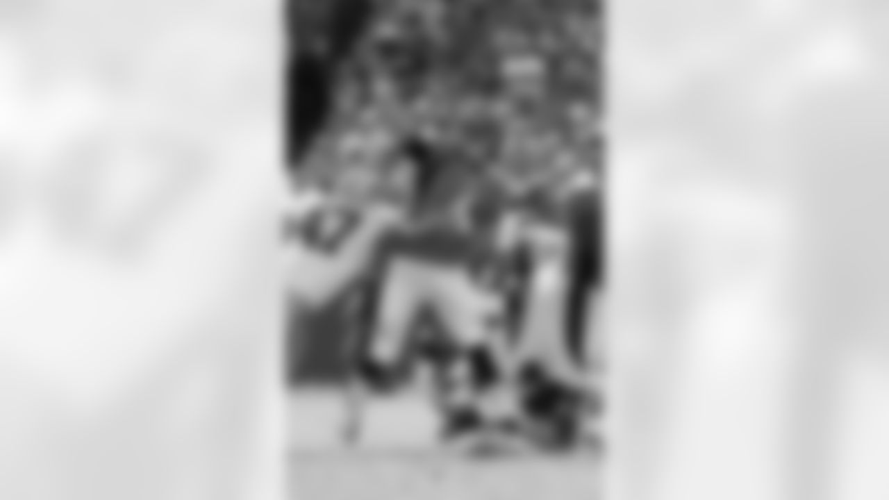Osweiler throws a pass while being hit.