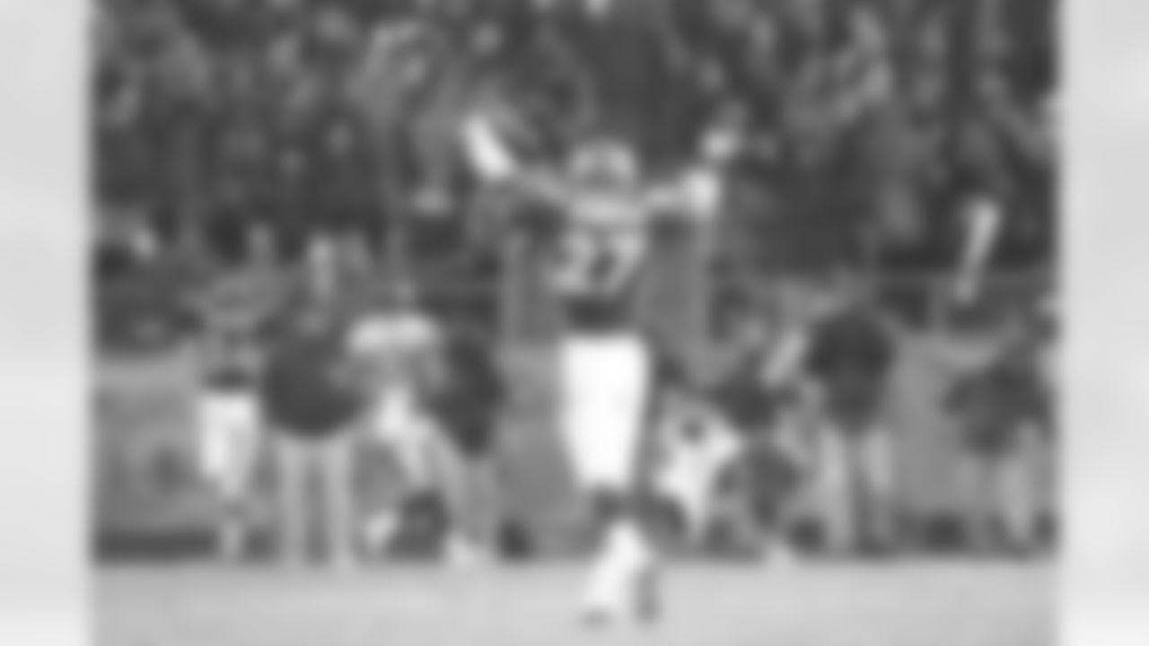 Denver: Safety Steve Atwater raises his arms in celebration as he watches one of his teammates make an interception against the Jaguars against the Jacksonville Jaguars at Mile High Stadium in Denver, CO on December 27, 1997.