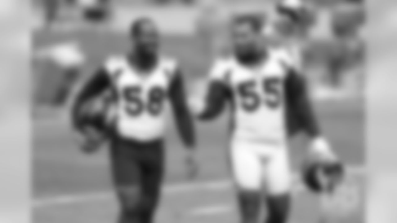 Von Miller and Bradley Chubb share a laugh during the first day of voluntary veteran minicamp on April 16, 2019.