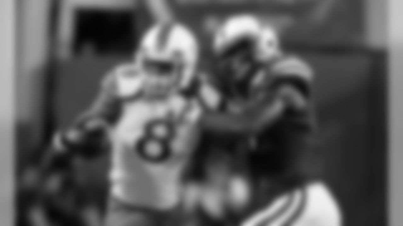 Miami running back Duke Johnson tries to shrug off a tackle by Nebraska safety Corey Cooper.