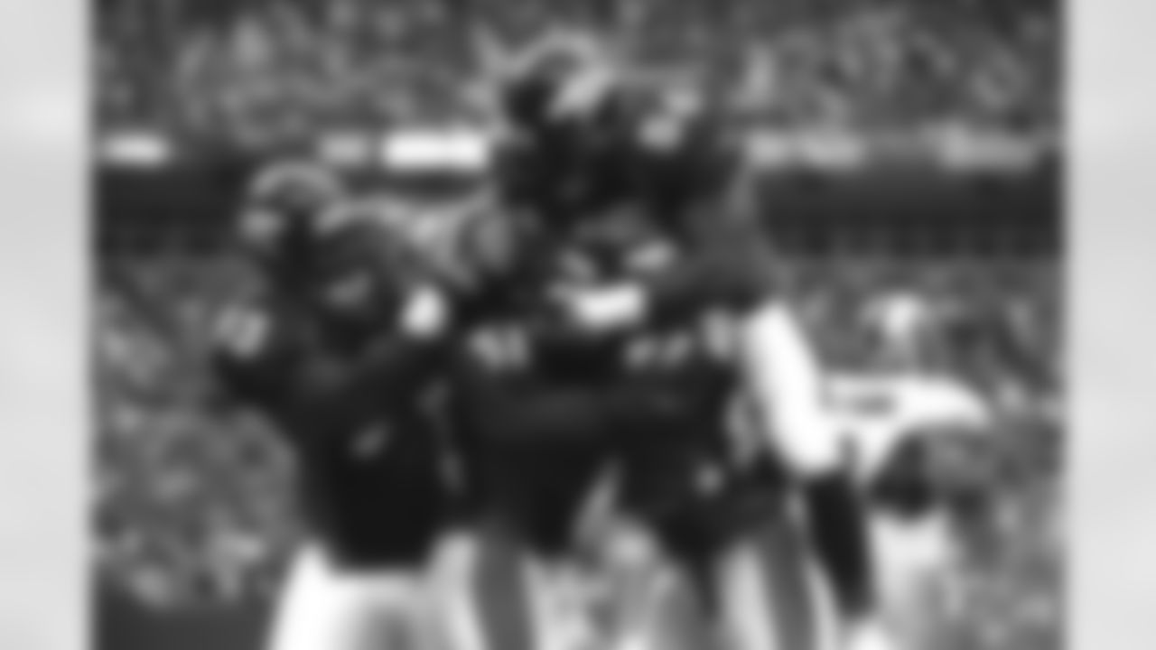 Trevor Pryce (93), Al Wilson (56), and Keith Washington (97) all celebrate after John Mobley (51) returned an interception for a touchdown during a preseason game against the San Francisco 49ers at Invesco Field at Mile High in Denver, CO on August 31, 2001.