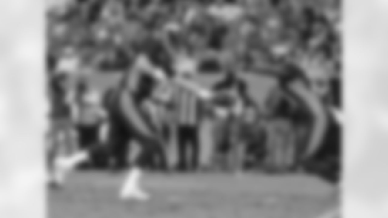 QB Peyton Manning hands off to RB Ronnie Hillman.