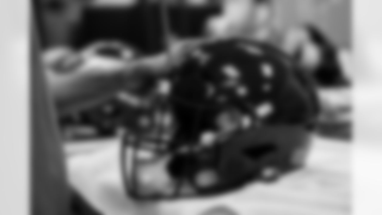 Members of the equipment staff place Color Rush decals on players' helmets at UCHealth Training Center in Englewood, Colorado on November 9, 2021. (Photo by Ben Swanson)