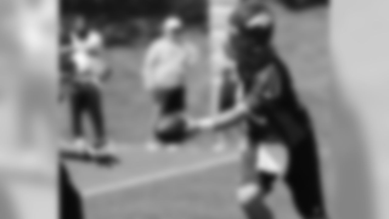 Manning hands the ball off.