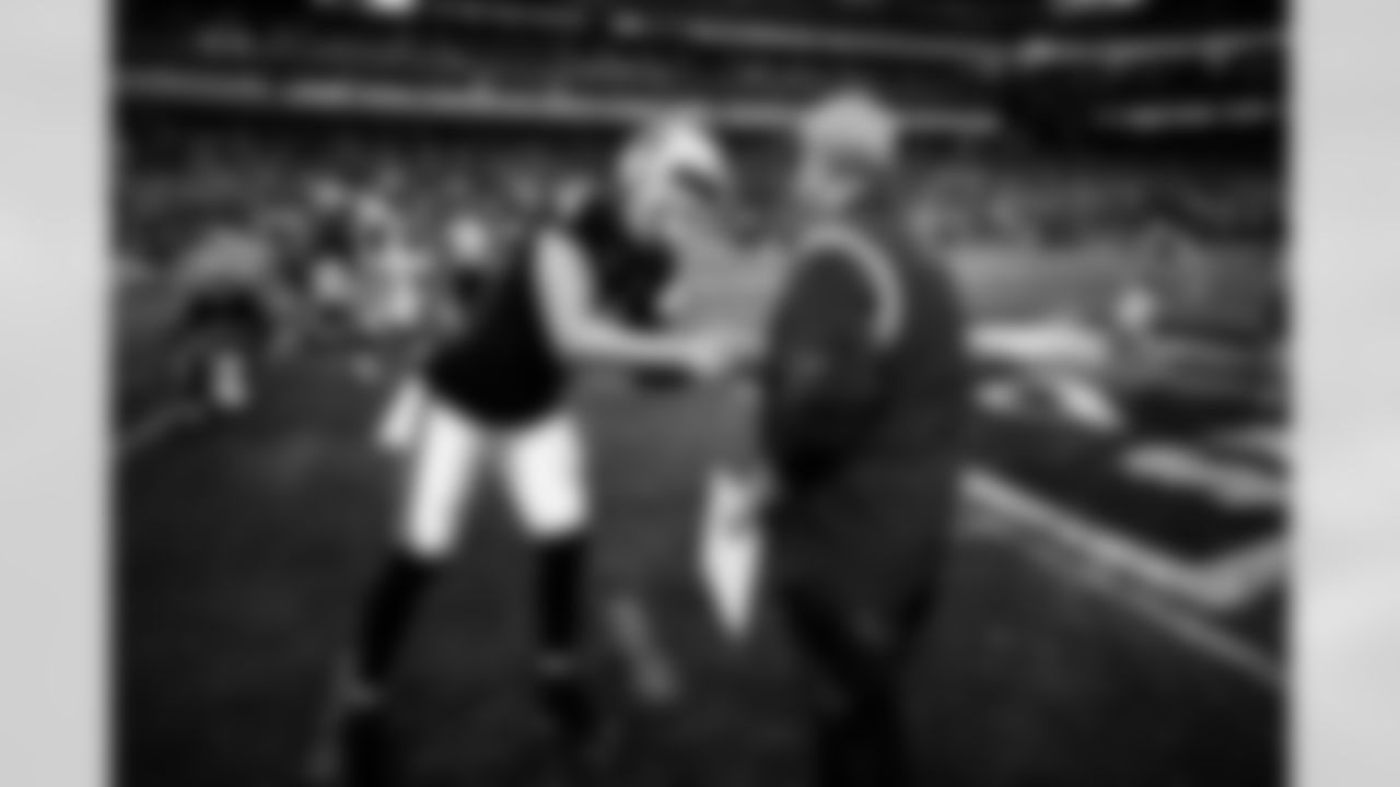Denver Broncos head coach Vic Fangio shakes hands with Las Vegas Raiders quarterback Derek Carr (4) during the NFL game against the Las Vegas Raiders on Sunday, December 26, 2021 at Allegiant Stadium in Las Vegas, Nevada.