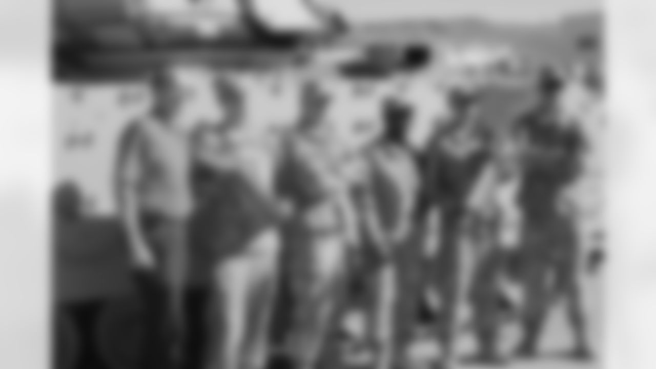 Gradishar and the troops pose for a picture with the Broncos' Super Bowl trophies.