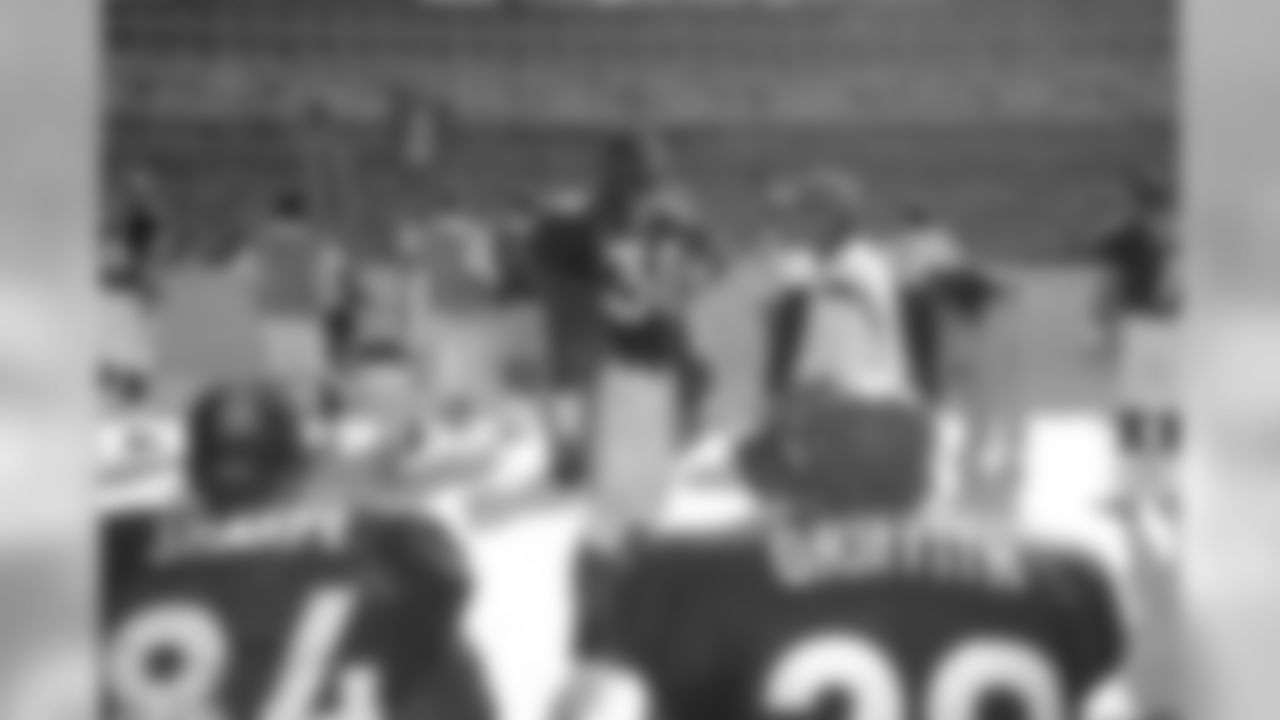 Terrell Davis chats with his teammates along the sidelines during a game against Washington at FedEx Field in Landover, MD on September 27, 1998.