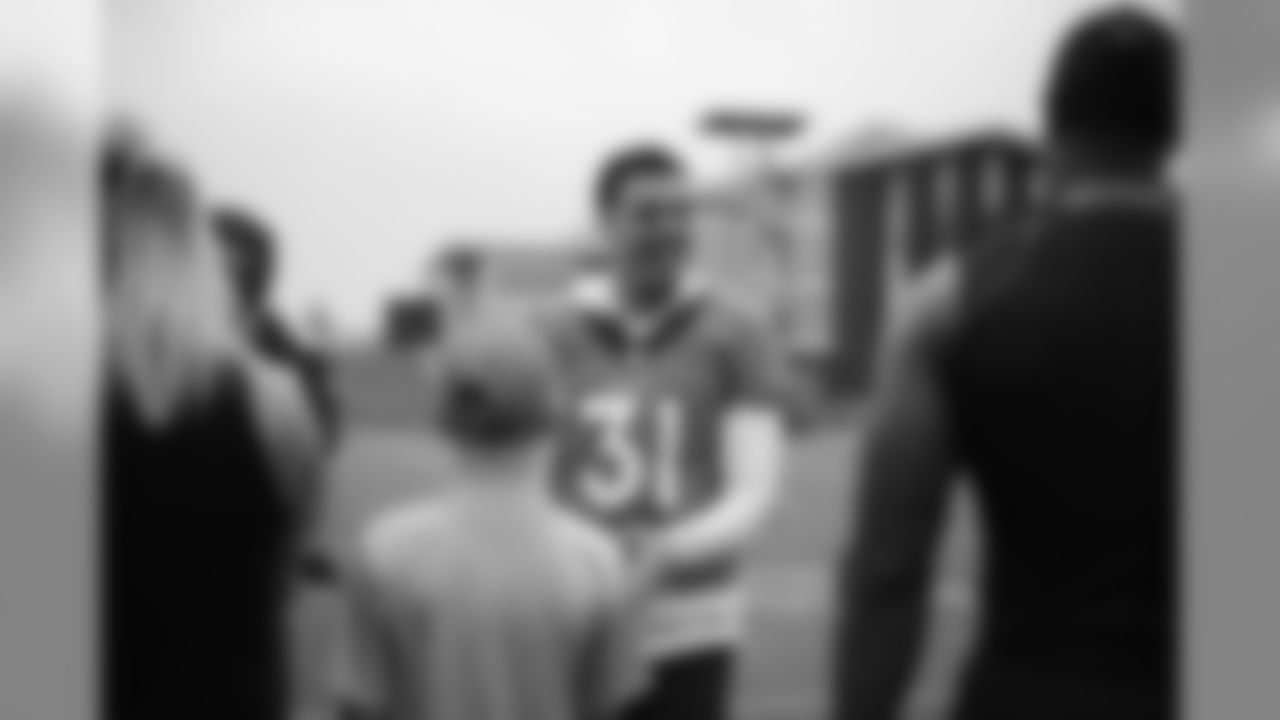Justin Simmons signs autographs for military members from the USAA Salute to Service NFL Boot Camp after practice on August 21, 2019 at UCHealth Training Center.