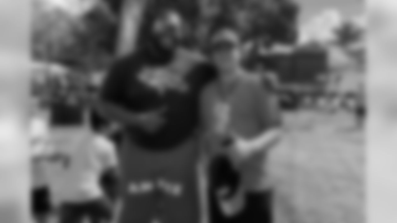 Zach Kerr takes a photo with a Broncos fan during the Tochito National Tournament on February 9, 2019, as a player ambassador for the flag football tournament.