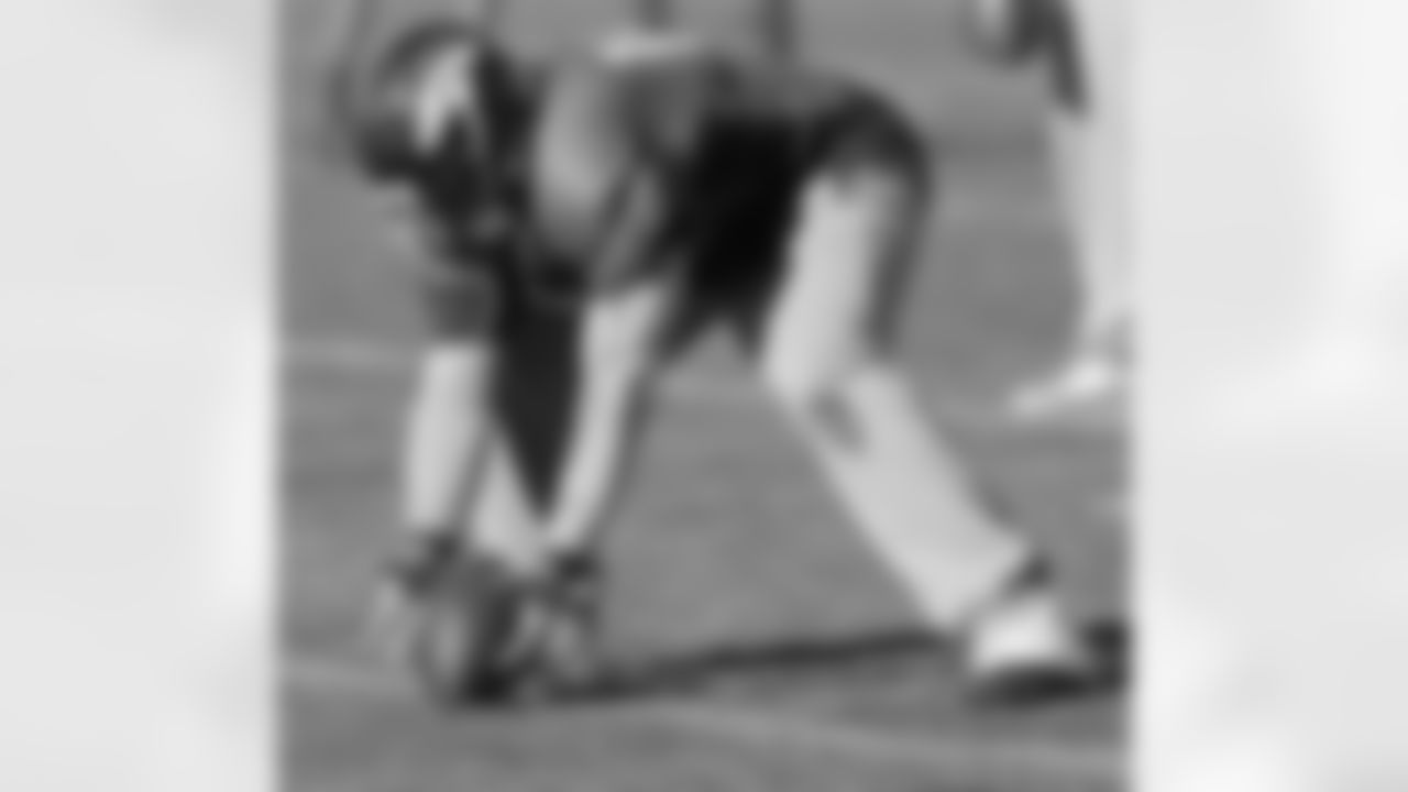 QB Caleb Hanie reaches down for a low snap.