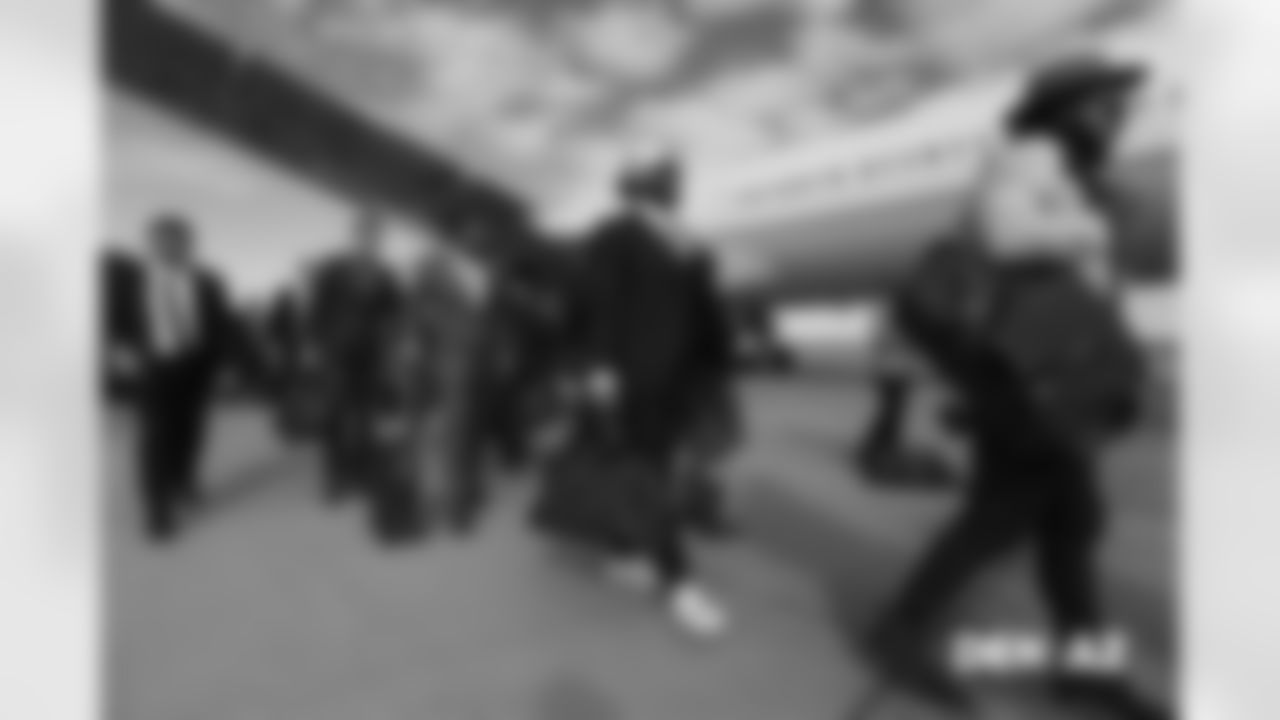 Max Garcia walks on the tarmac to the plane before the flight during the team's travel for their Week 7 game against the Arizona Cardinals on October 17, 2018.