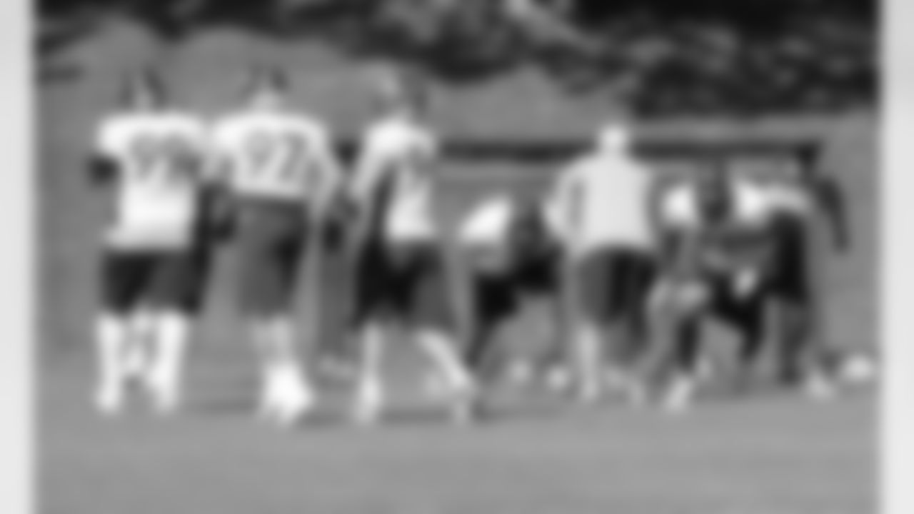 The defensive line works through a drill together.