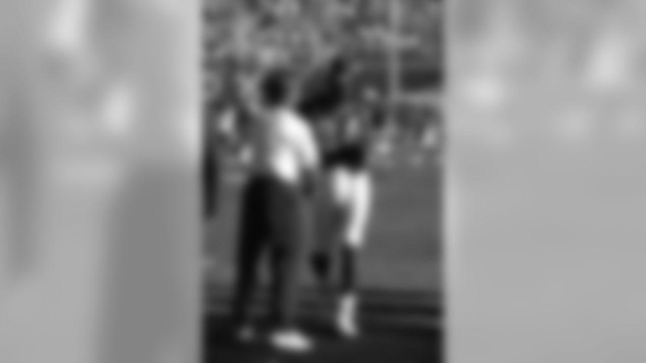 Head Coach Mike Shanahan shakes the hand of Shannon Sharpe during pregame warmups before Super Bowl XXXII against the Green Bay Packers on January 25, 1998.