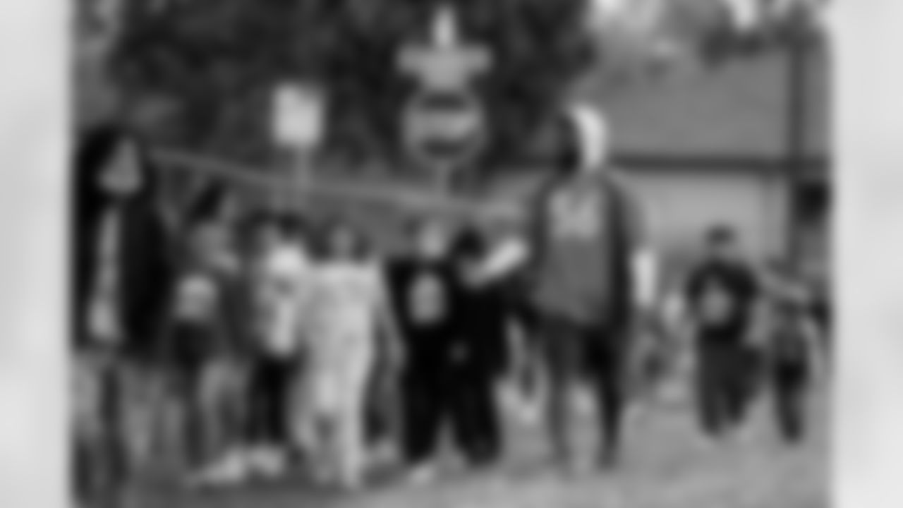 Baron Browning walks with children during the Miles for Miles walk week community event at Johnson Elementary School in Denver, Colorado, encouraging children to be active on October 12, 2021. (Photo by Ben Swanson)