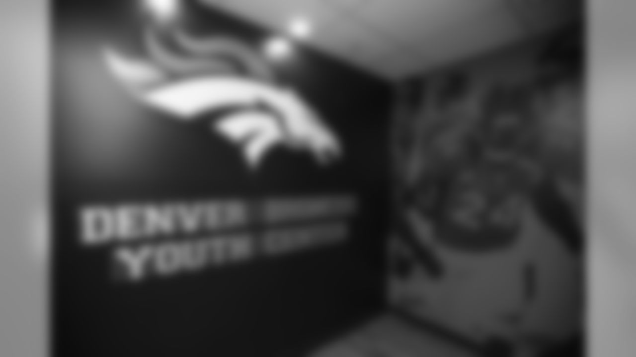 At the entryway for the renovated Denver Broncos Youth Center at the Denver Rescue Mission's 20th annual holiday party at the Mission's The Crossing location on December 9, 2019. (Photo by Ben Swanson)