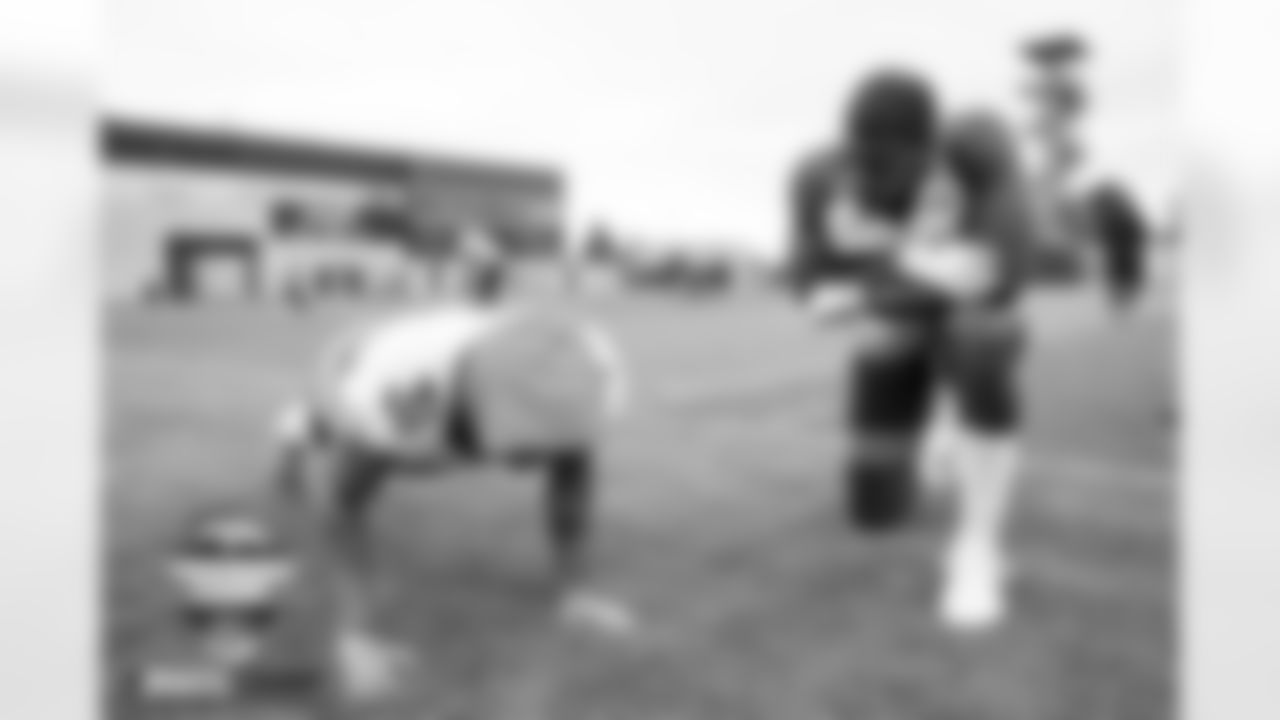 Justin Simmons does pushups as Aaron Patrick watches at practice on Day 2 of training camp at UCHealth Training Center in Englewood, Colorado on July 28, 2022. (Photo by Ben Swanson)