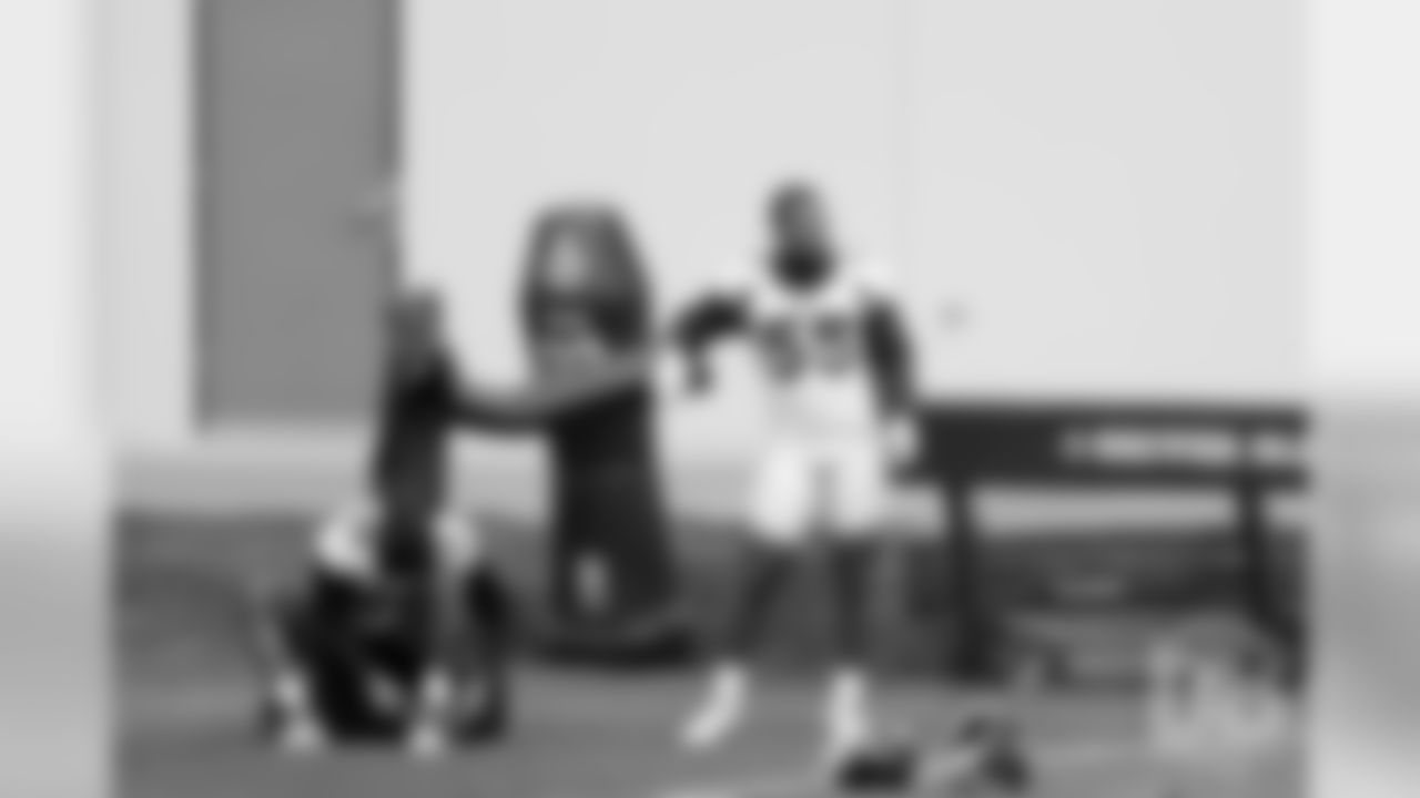 Von Miller and Bradley Chubb rest for a moment during the first day of voluntary veteran minicamp on April 16, 2019.