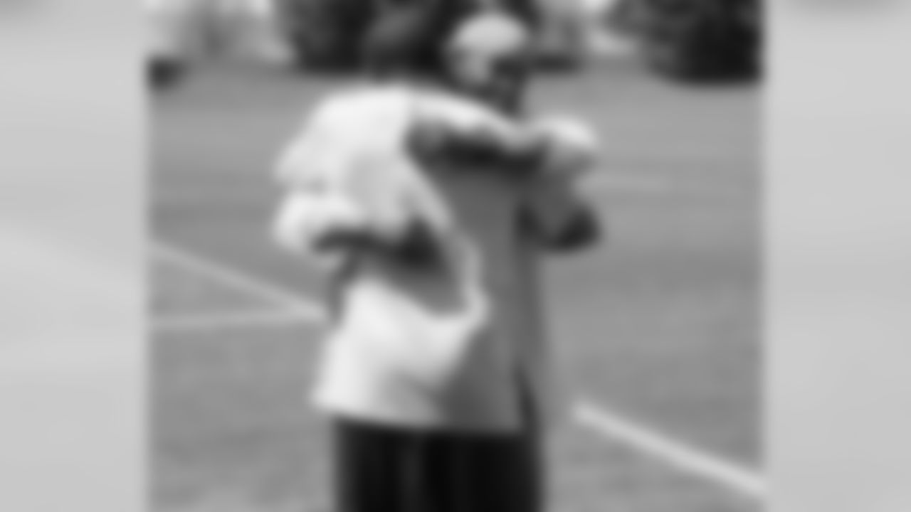 Dawkins shares a hug with Wesley Woodyard.