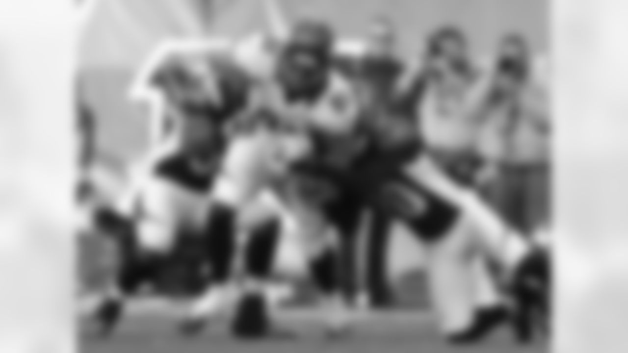 Dreessen runs through a pair of Bengals defenders.