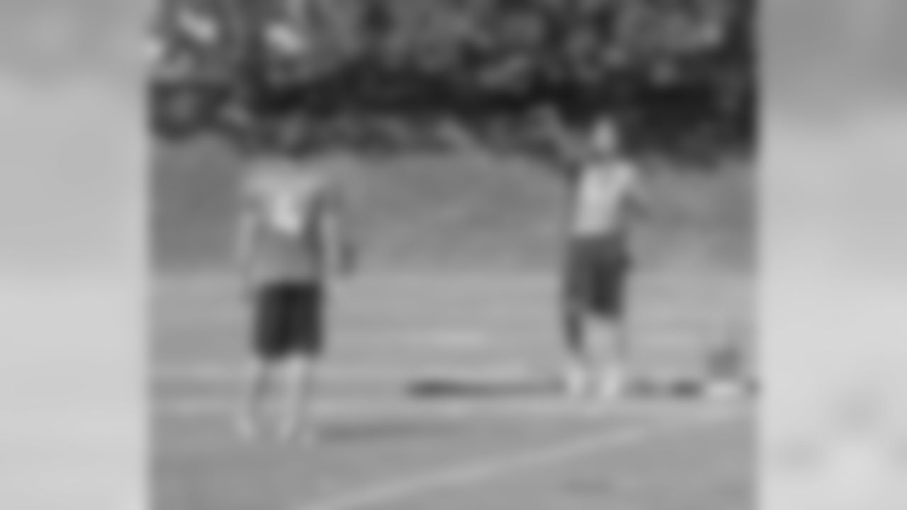 LS Aaron Brewer and P Britton Colquit play catch during a break in practice.