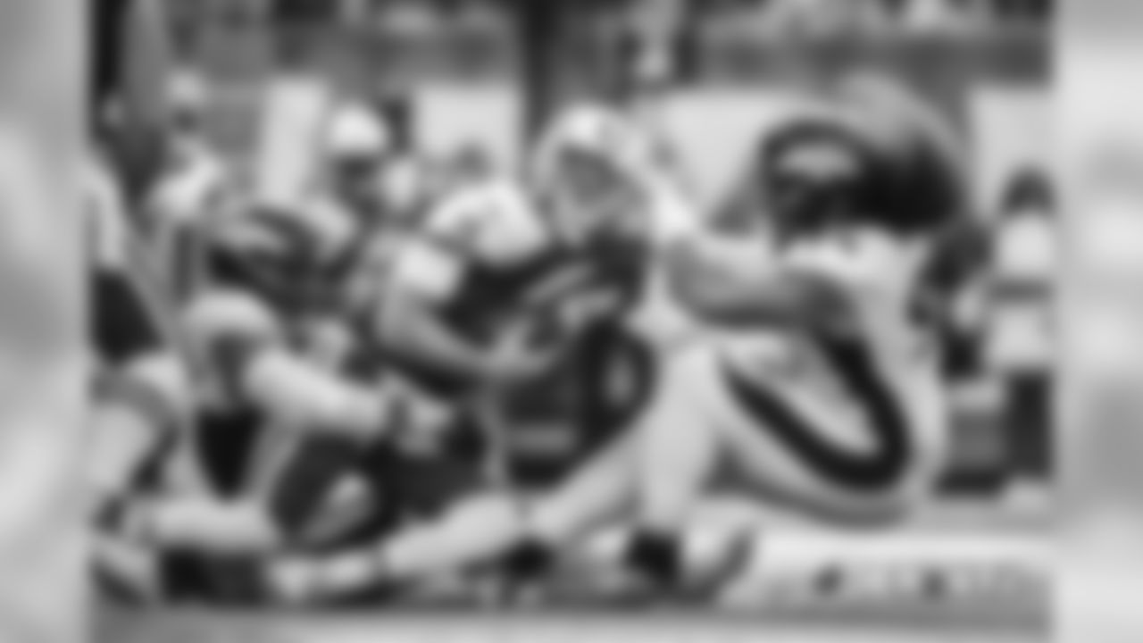Domata Peko Sr. and Derek Wolfe pull rookie quarterback Sam Darnold to the ground. The Broncos' defense has been one of the best at rushing the passer in 2018.