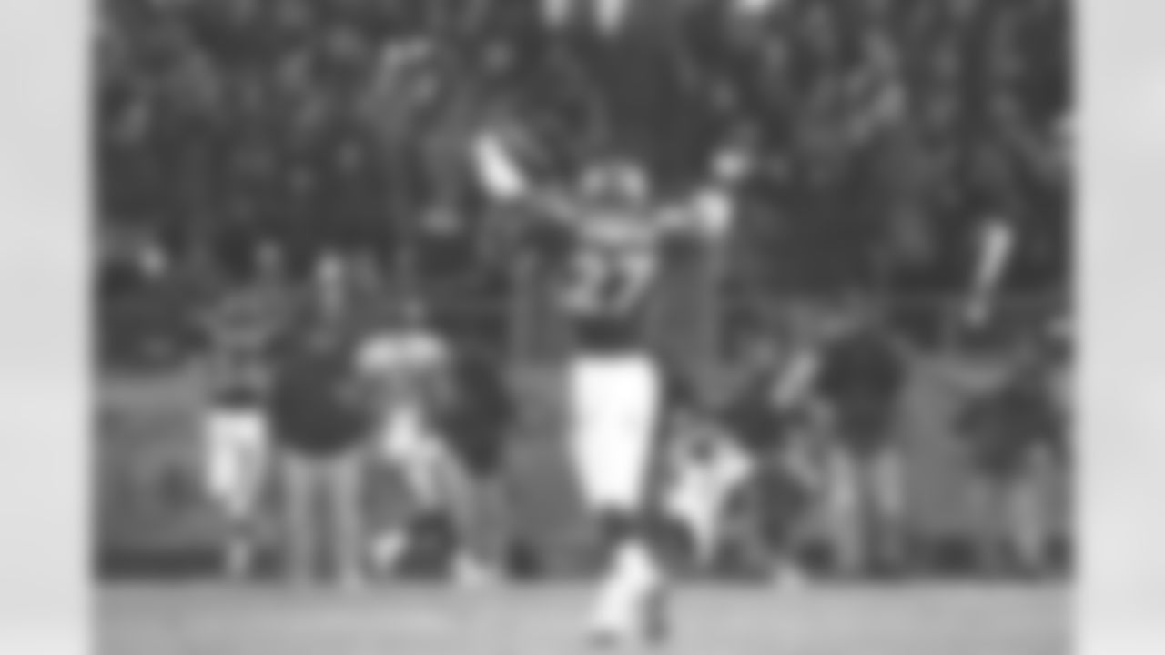 Denver: Safety Steve Atwater raises his arms in celebration as he watches one of his teammates make an interception against the Jaguars against the Jacksonville Jaguars at Mile High Stadium in Denver, CO on December 27, 1997.