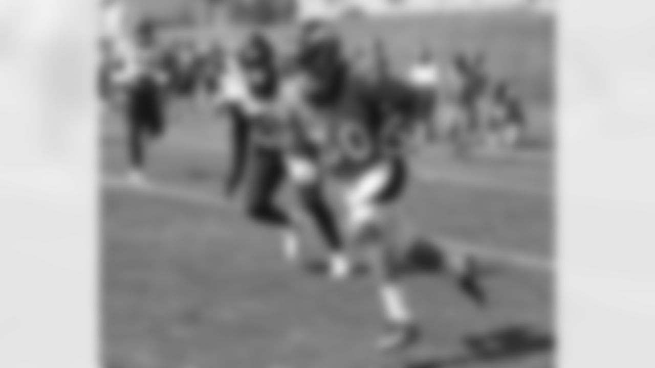Phillip Lindsay runs with the ball during the fifth training camp practice at UCHealth Training Center on August 19, 2020. (Photo by Ben Swanson)