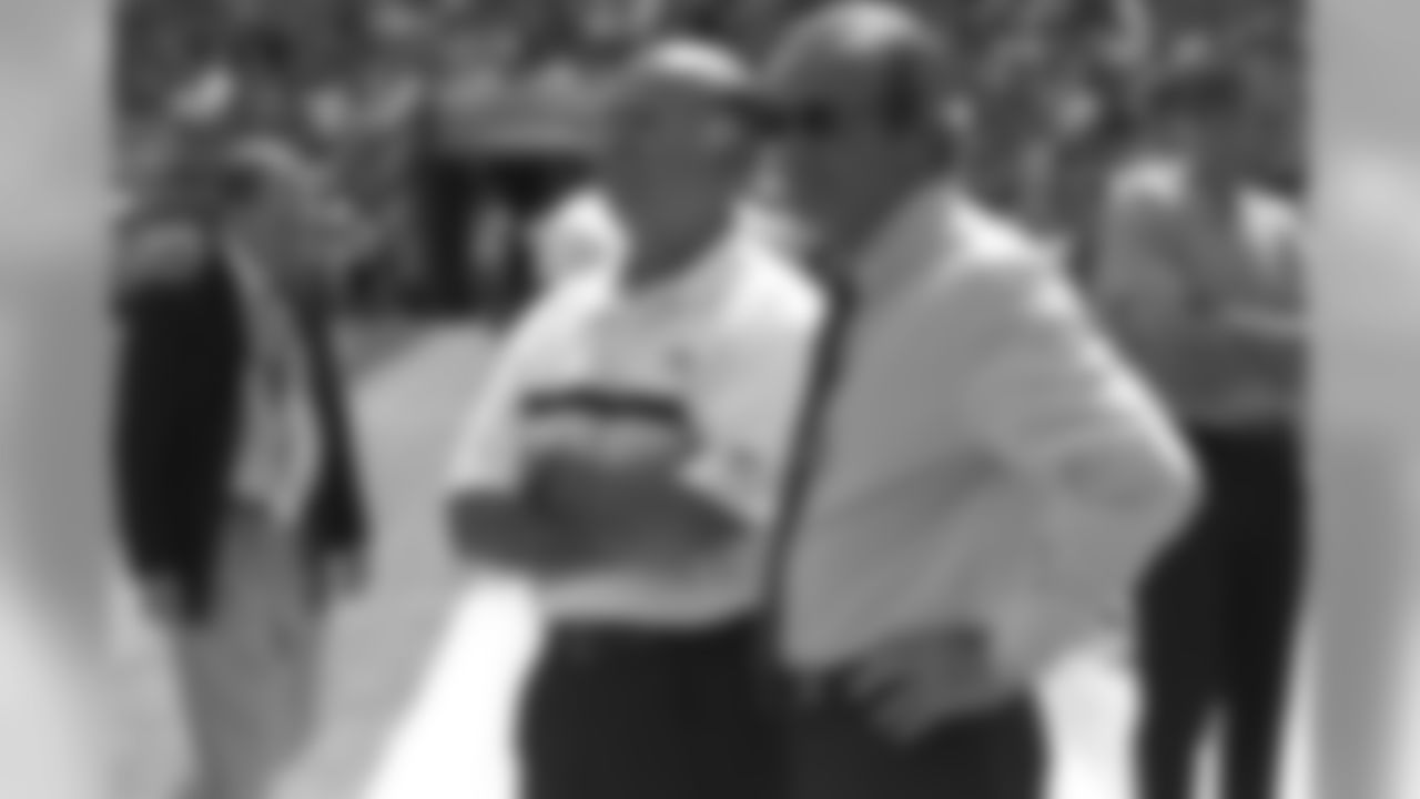 Pat Bowlen (right) chats with Steve Antonopolous (left) during the pre game drills against the St. Louis Rams at Invesco Field at Mile High in Denver, CO on September 8, 2002.