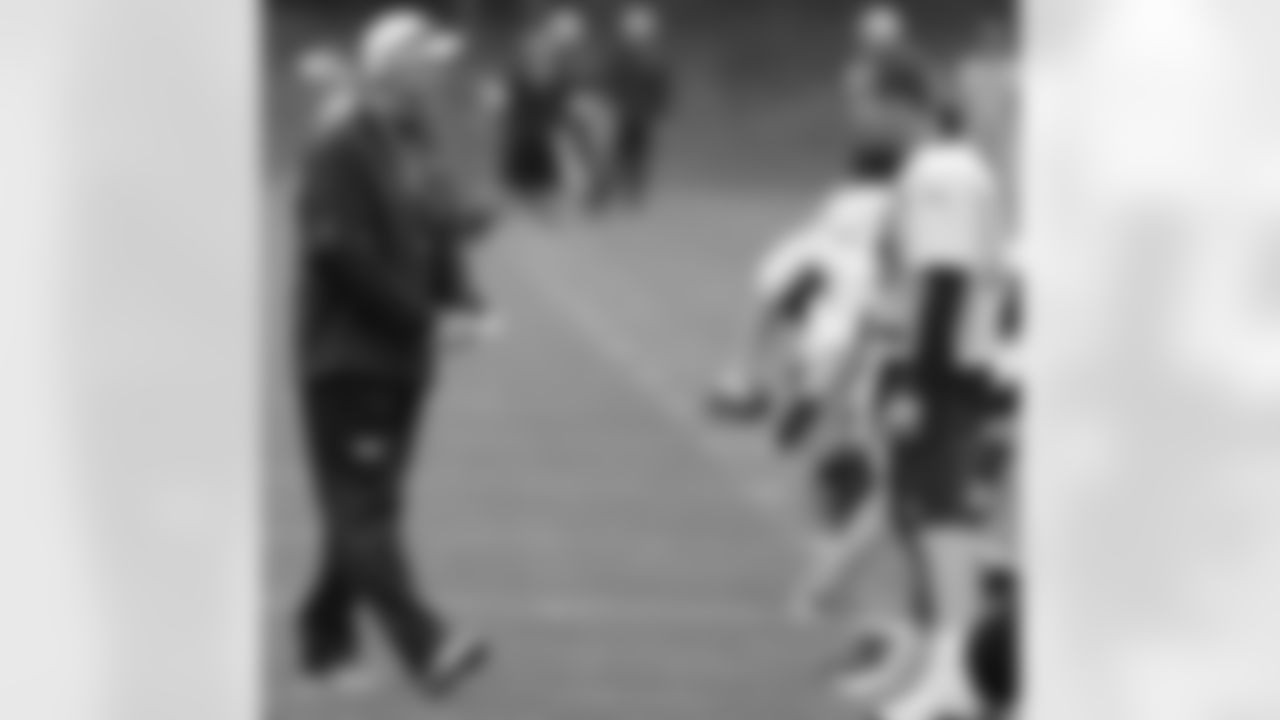 Manning laughs with Head Coach John Fox.