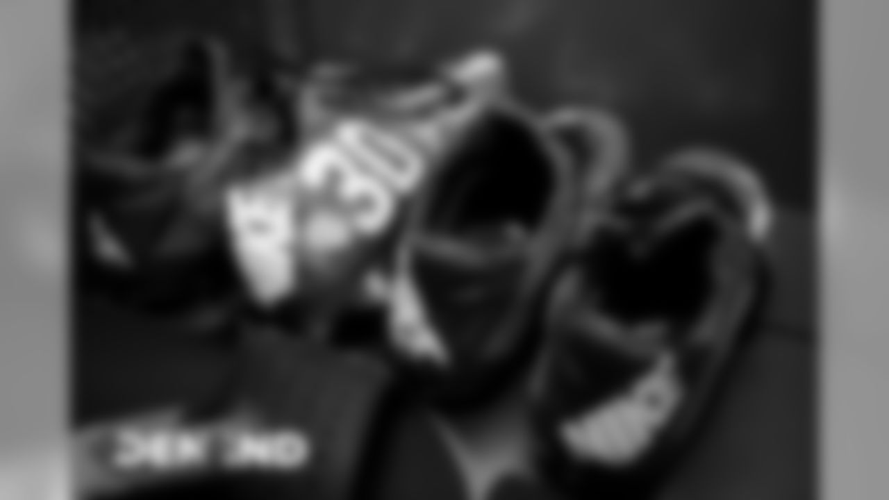 Phillip Lindsay's cleats in the visiting locker room for the Broncos' game against the Indianapolis Colts at Lucas Oil Stadium on October 27, 2019. (Photo by Ben Swanson)