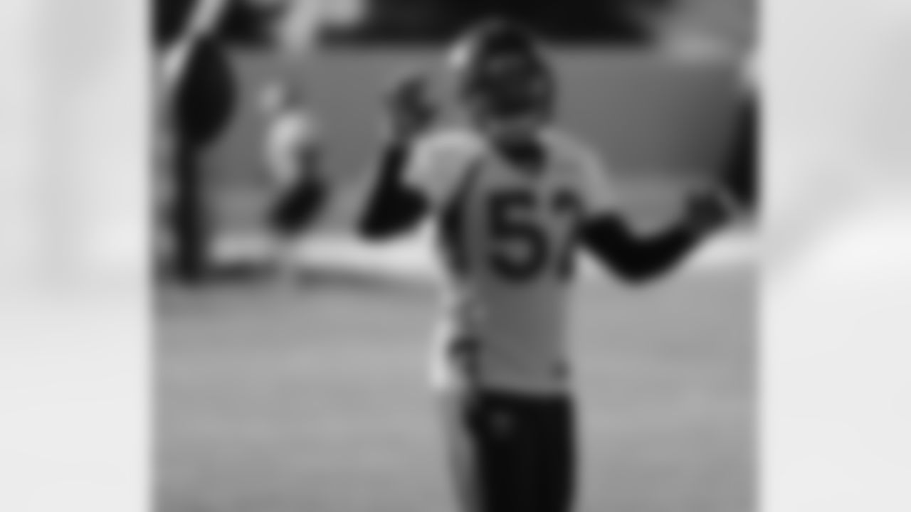 Woodyard tosses the ball to a coach after making a catch.