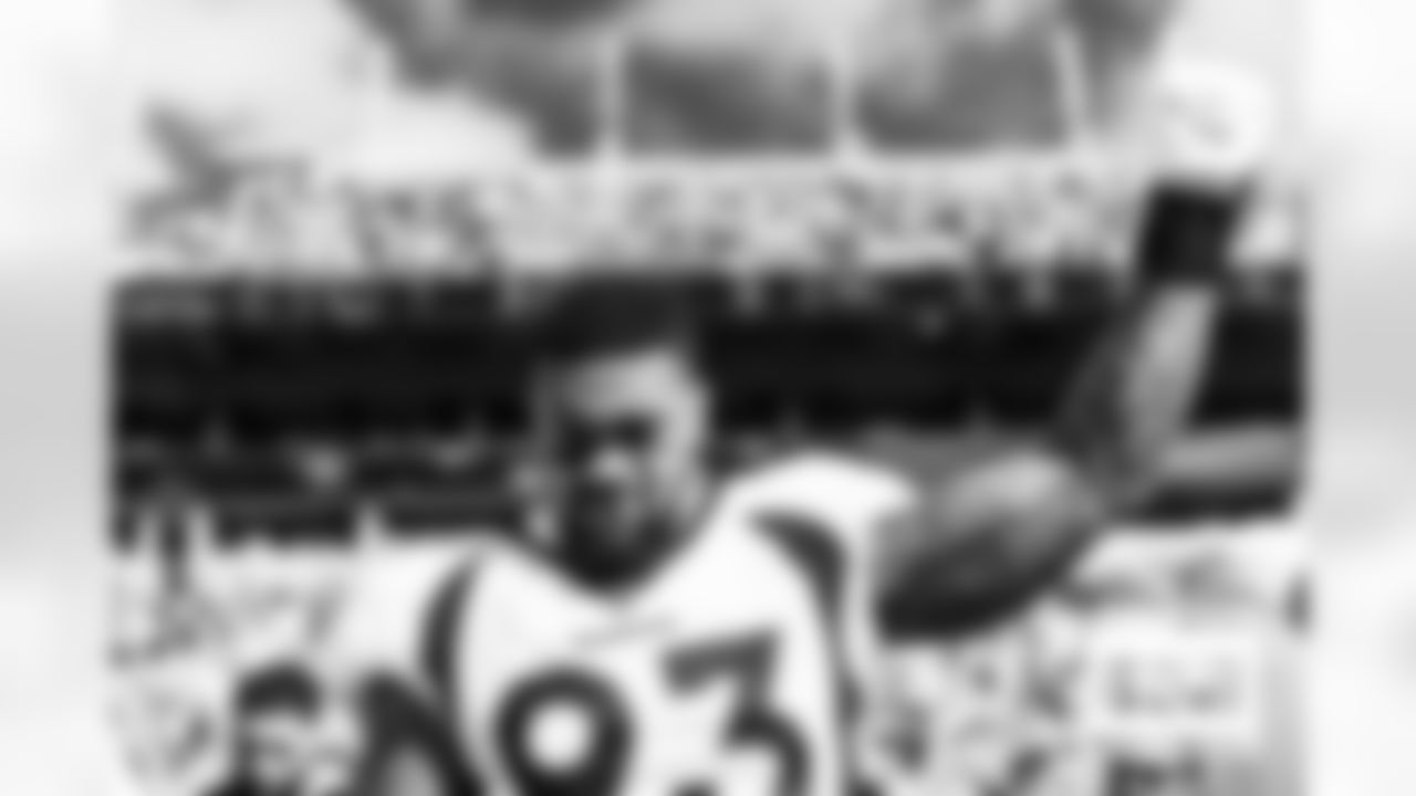 Dre'Mont Jones on the sideline during the national anthem before the Broncos' Week 12 game against the Carolina Panthers at Bank of America Stadium in Charlotte, North Carolina on November 27, 2022. (Photo by Ben Swanson)