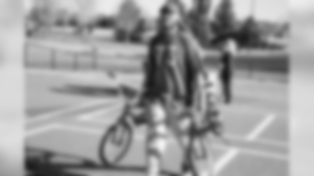 Andreas Knappe carries bikes during a bike distribution at Green Valley Elementary School in Denver on December 18, 2018.