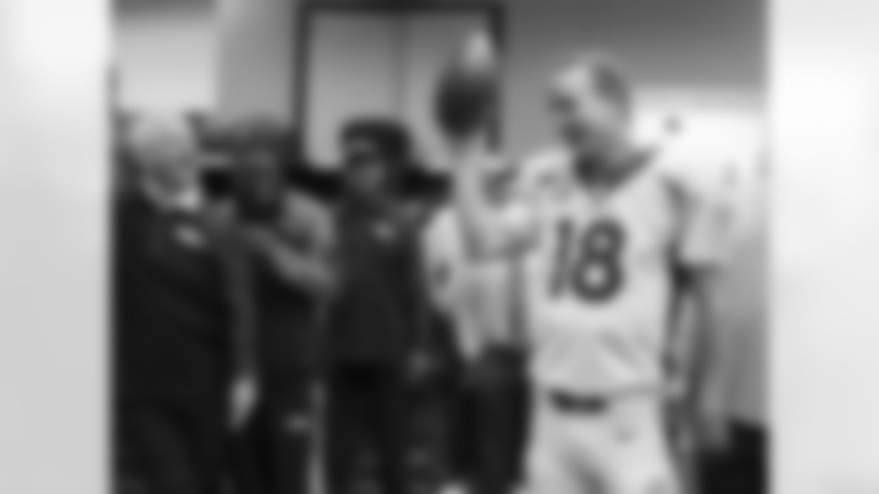 Denver Broncos quarterback Peyton Manning (18) accepts a game ball and addresses the team after he set a new NFL record for most touchdown passes (51) in a single regular season of play after Denver defeated the Houston Texans 37-13 in the NFL game in Houston TX December 22, 2013.