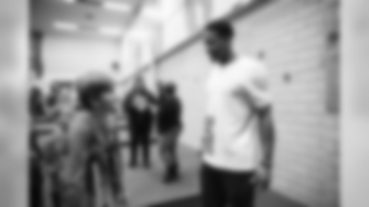 Children at Greenlee Elementary School receive shoes from Courtland Sutton as part of Shoes That Fit, an event with Snooze to help kids get shoes just before the holidays, on December 2, 2019. (Photo by Jeremy Rincon)