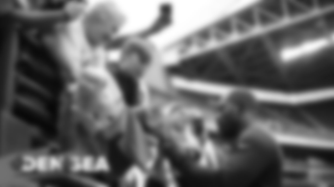 Von Miller signs autographs before a preseason game against the Seattle Seahawks at CenturyLink Field in Seattle on August 8, 2019.