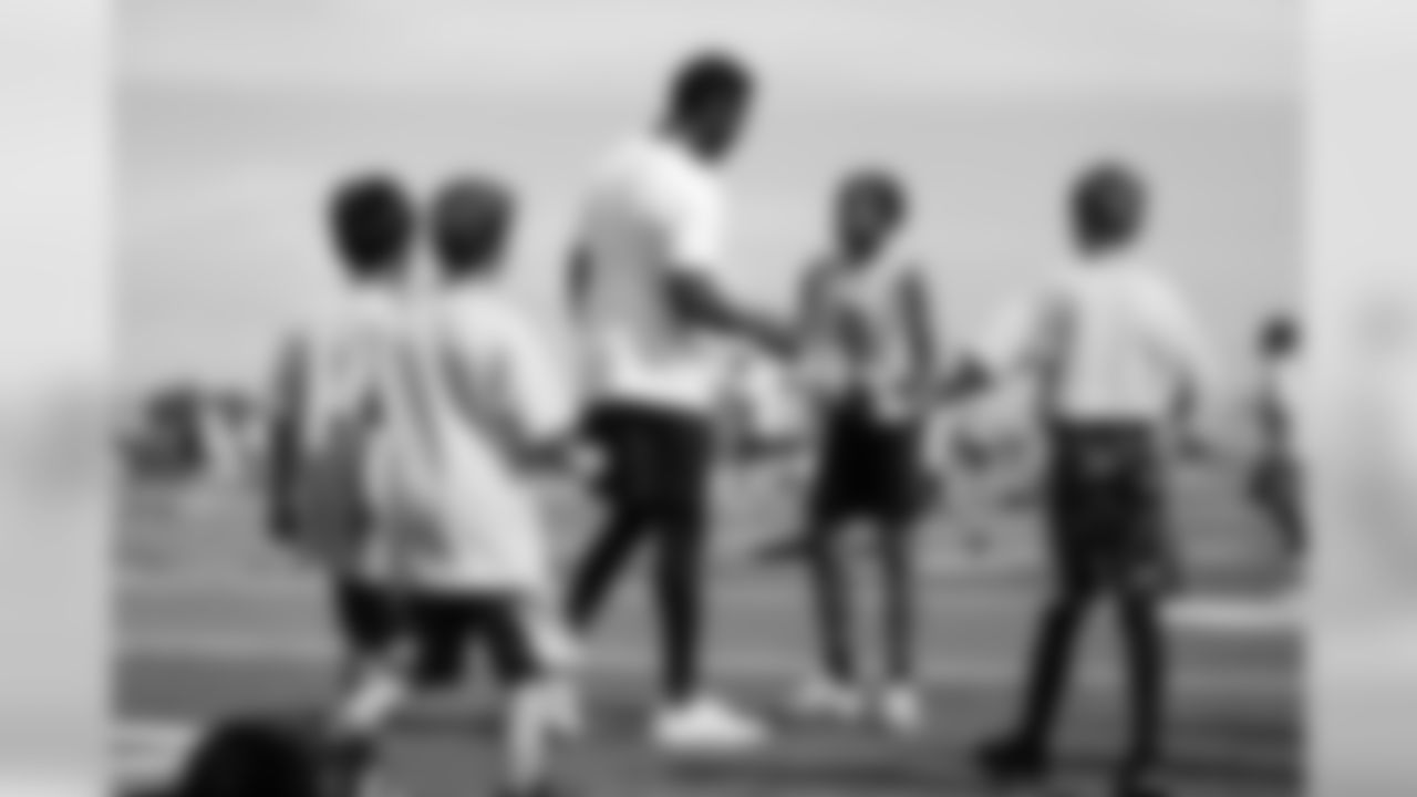 Emmanuel Sanders interacts with children at his youth football camp at Thomas Jefferson High School in Denver on July 1, 2019.